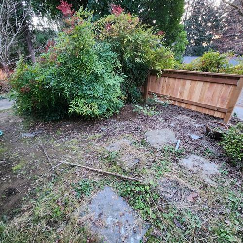 Area after building half-fence. pre-regrade, turf, gravel, gravel barrier, and herringbone installation