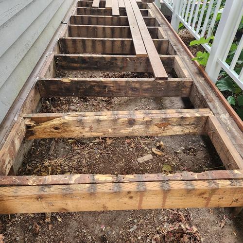 rotted joists improperly sistered with pressure treated joists, no hangers anywhere to be seen.