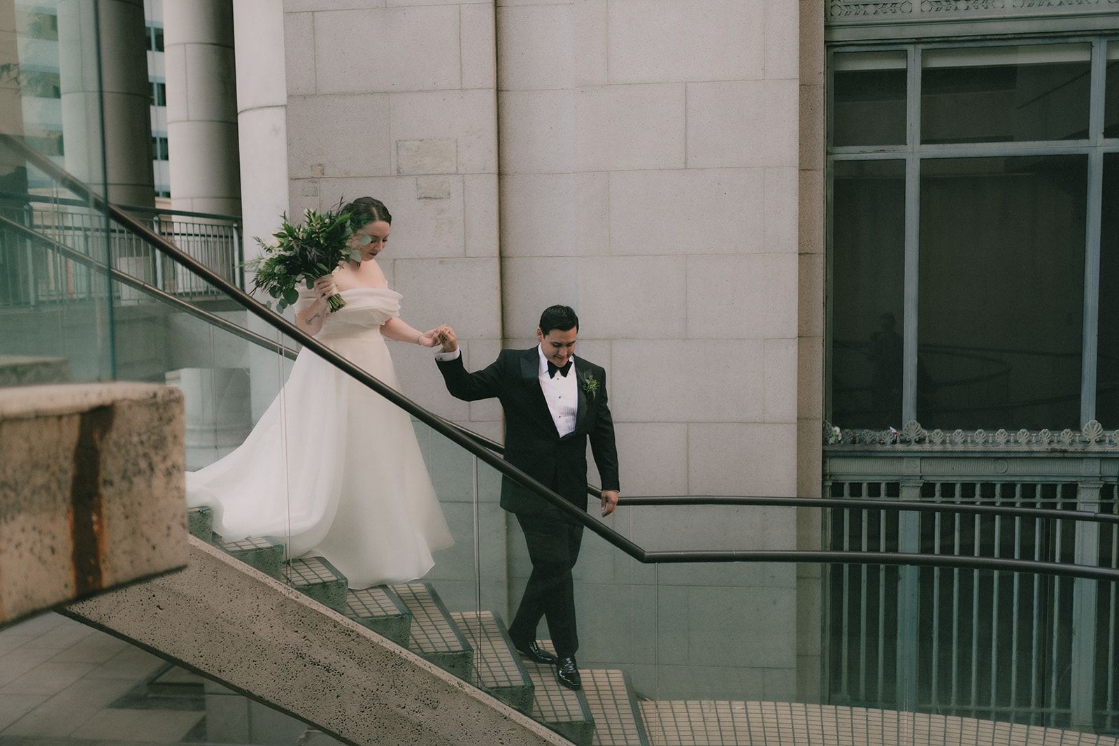 Anne and Charles walk down a modern outdoor staircase together in San Francisco.