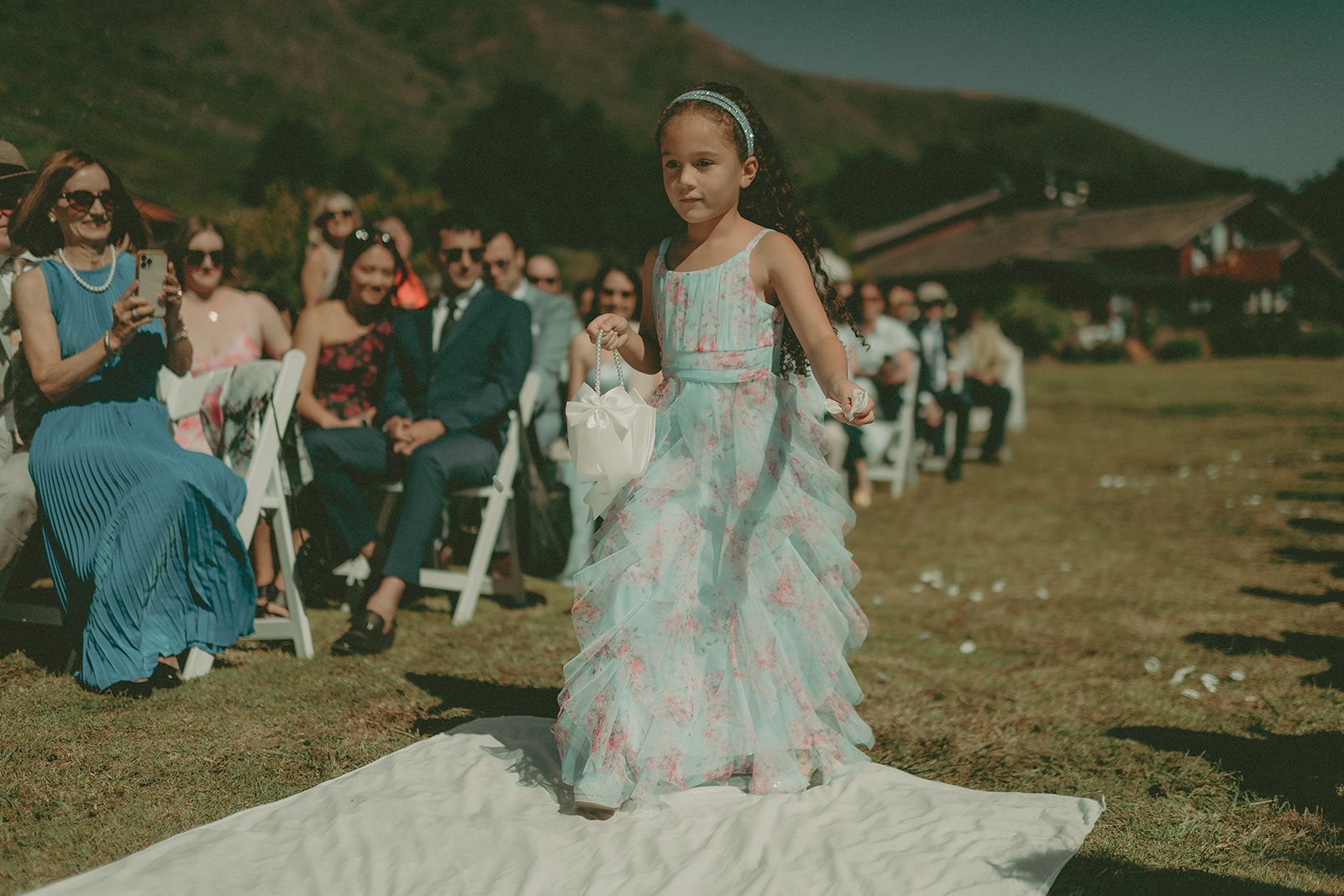 Bride moving through the ceremony aisle at a coastal wedding