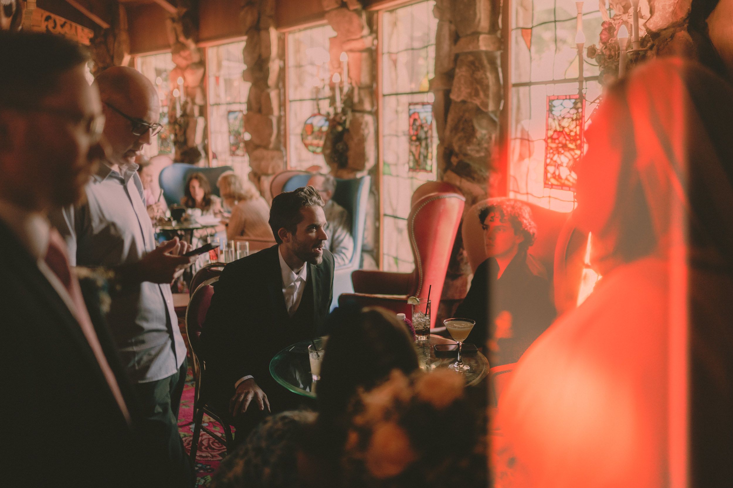 A warm light leak crosses Tiffani, Braden and their guests during the reception.
