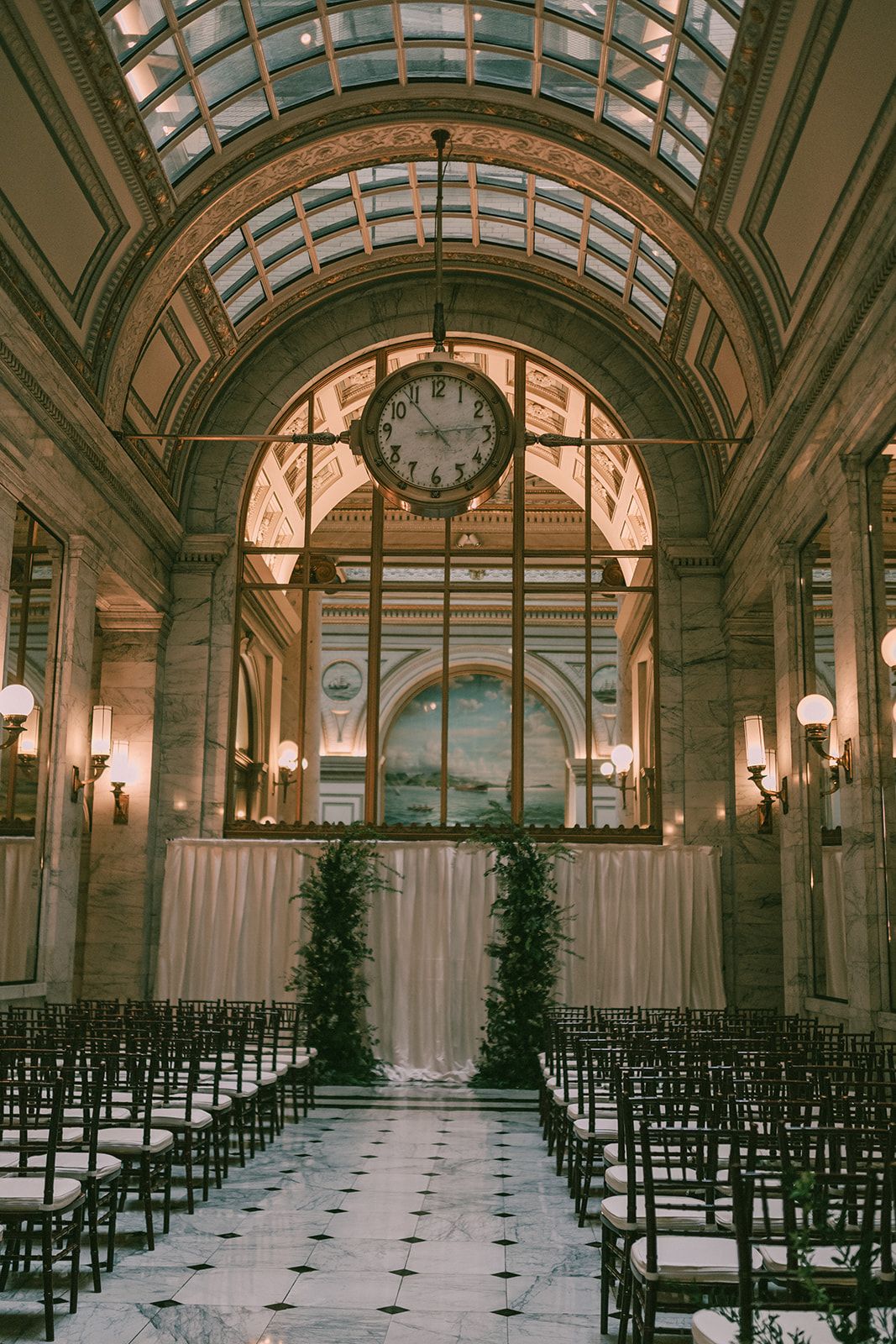The Julia Morgan Ballroom ceremony space arranged beneath its landmark clock and marble arches.