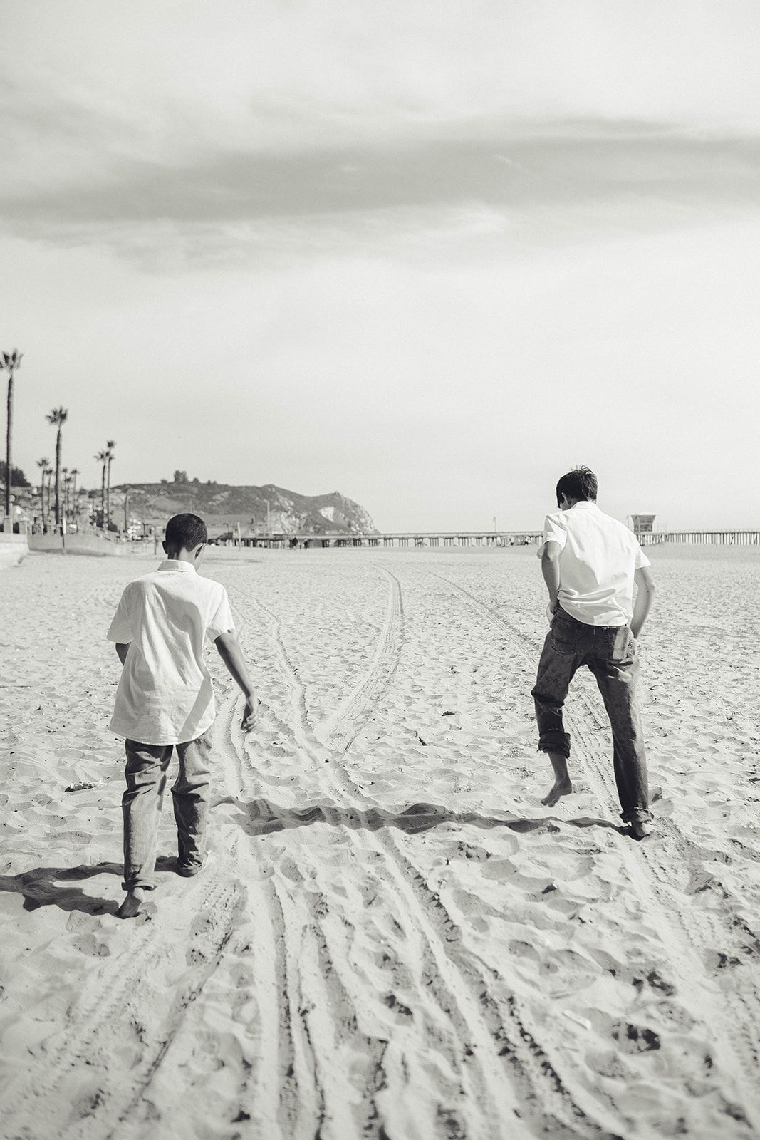 Black-and-white family action portrait on the beach