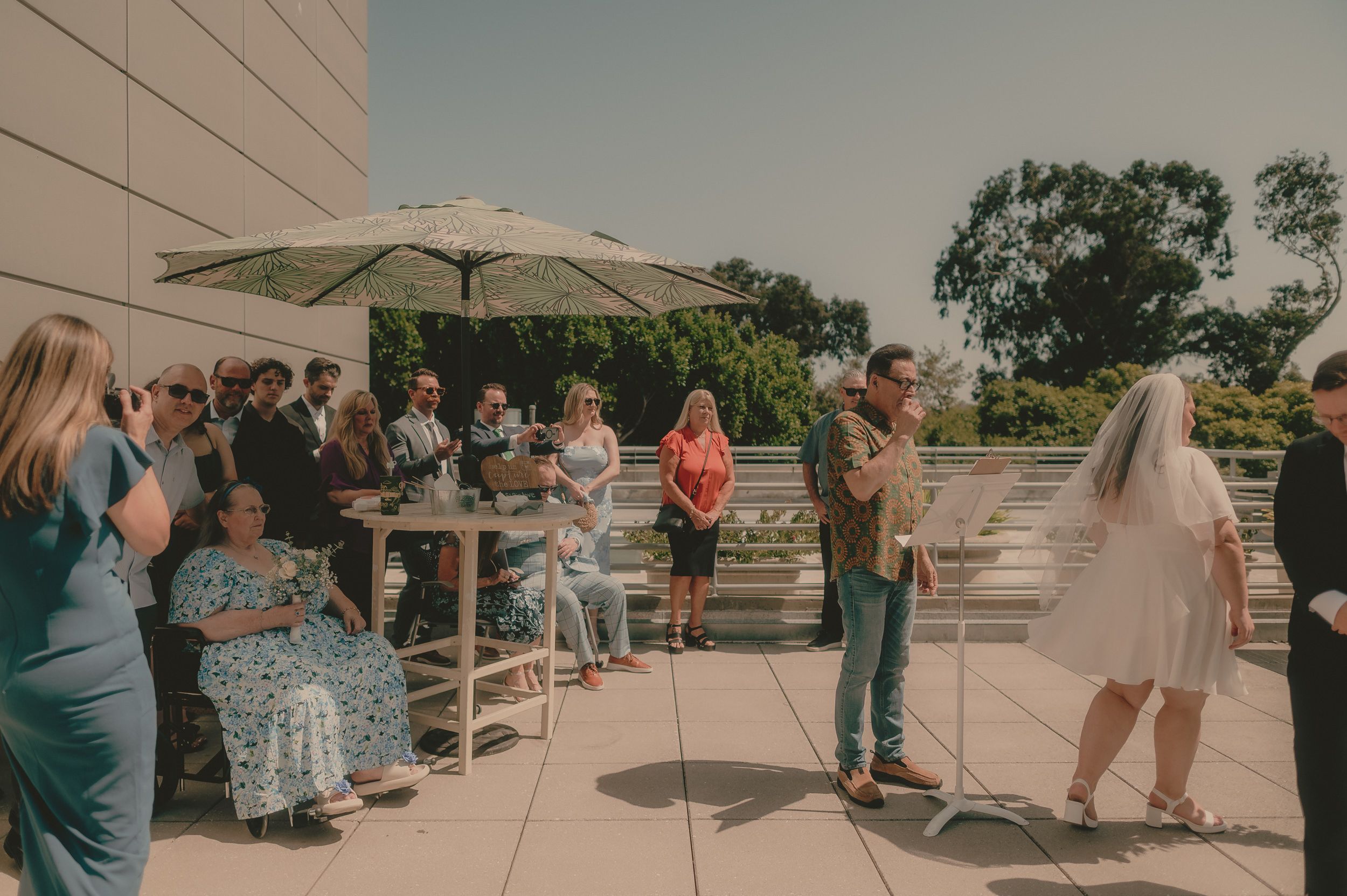Guests watch Tiffani and Braden's rooftop courthouse ceremony.