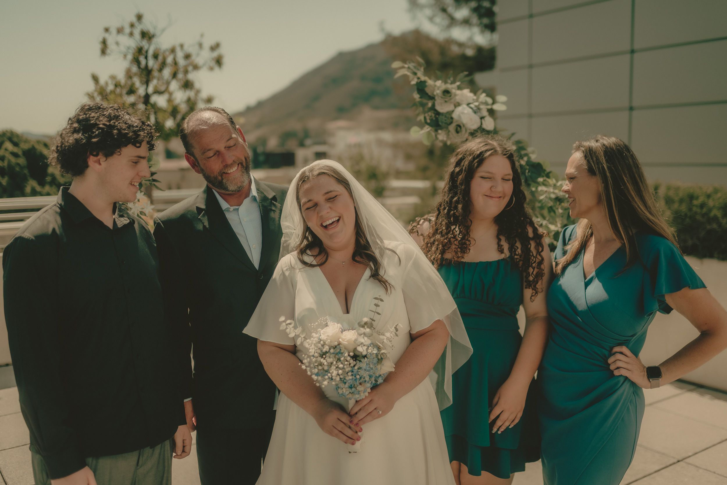 Tiffani laughs with guests after the rooftop courthouse ceremony.