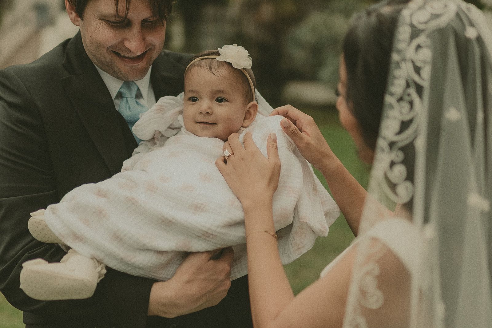 Newlyweds sharing a close family moment with their baby