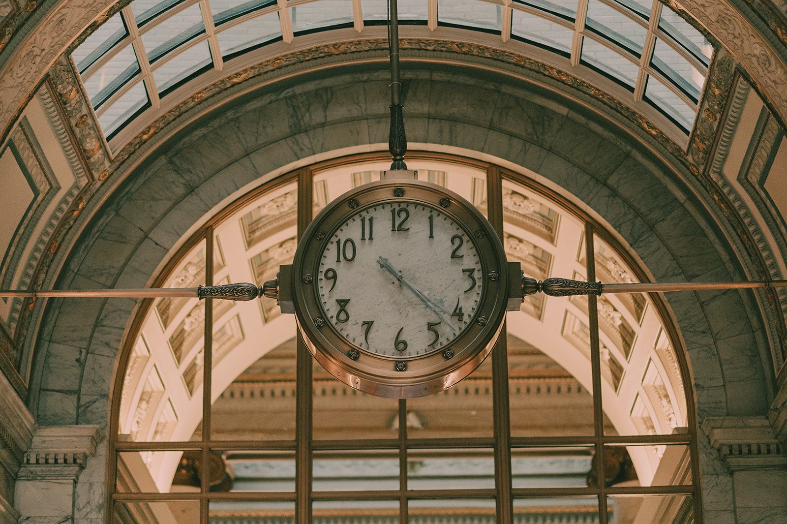 Close architectural portrait of the Julia Morgan Ballroom's historic clock and marble arch.