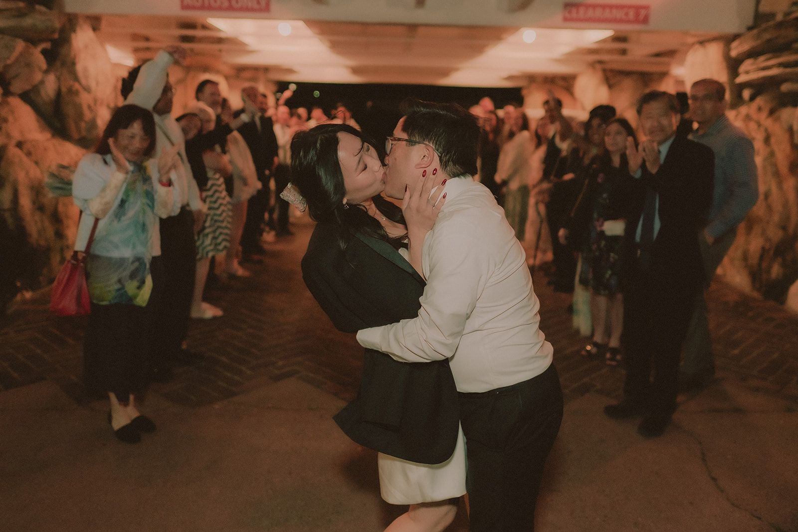 Newlyweds dancing with guests at a Madonna Inn reception