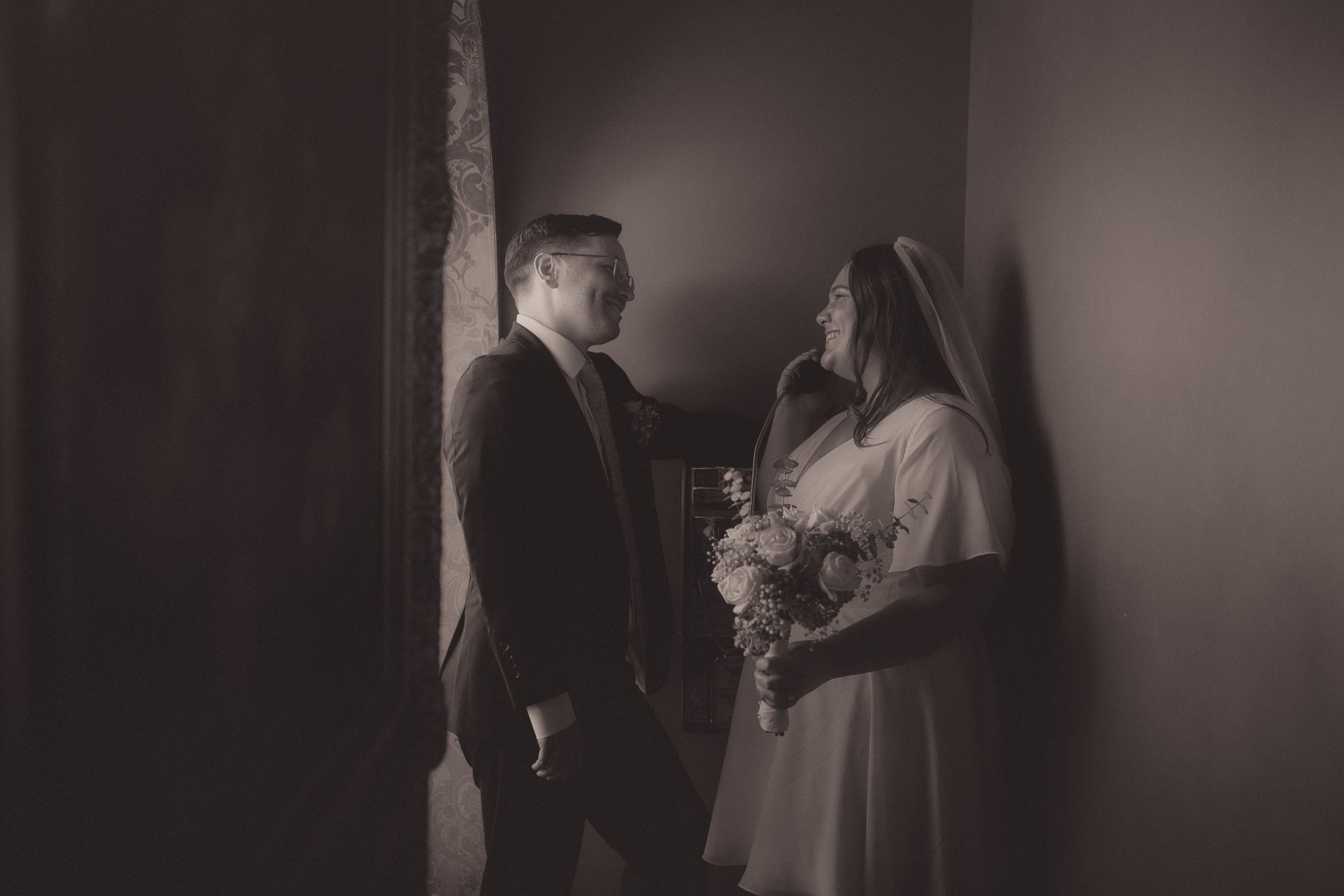 Tiffani and Braden pose together in a moody black-and-white Madonna Inn portrait.
