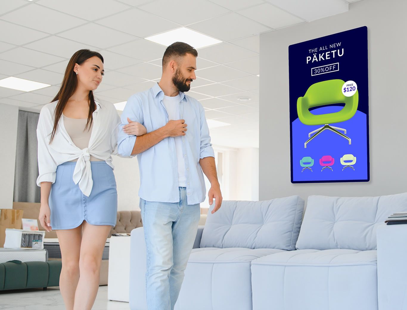 A couple walking through a furniture store and admiring a couch with Rockbot signage displayed on the back wall