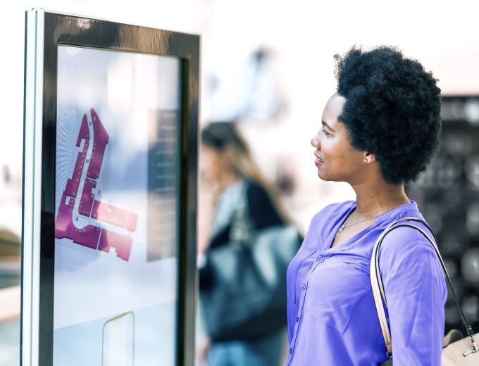 Woman looking at a large map display