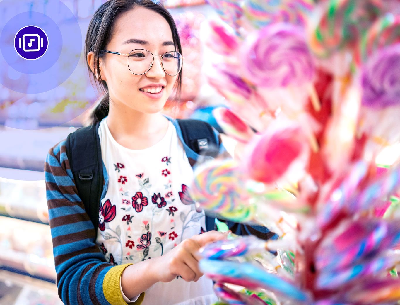 Woman in a candy store looking at lollipops with Rockbot music playing in the background