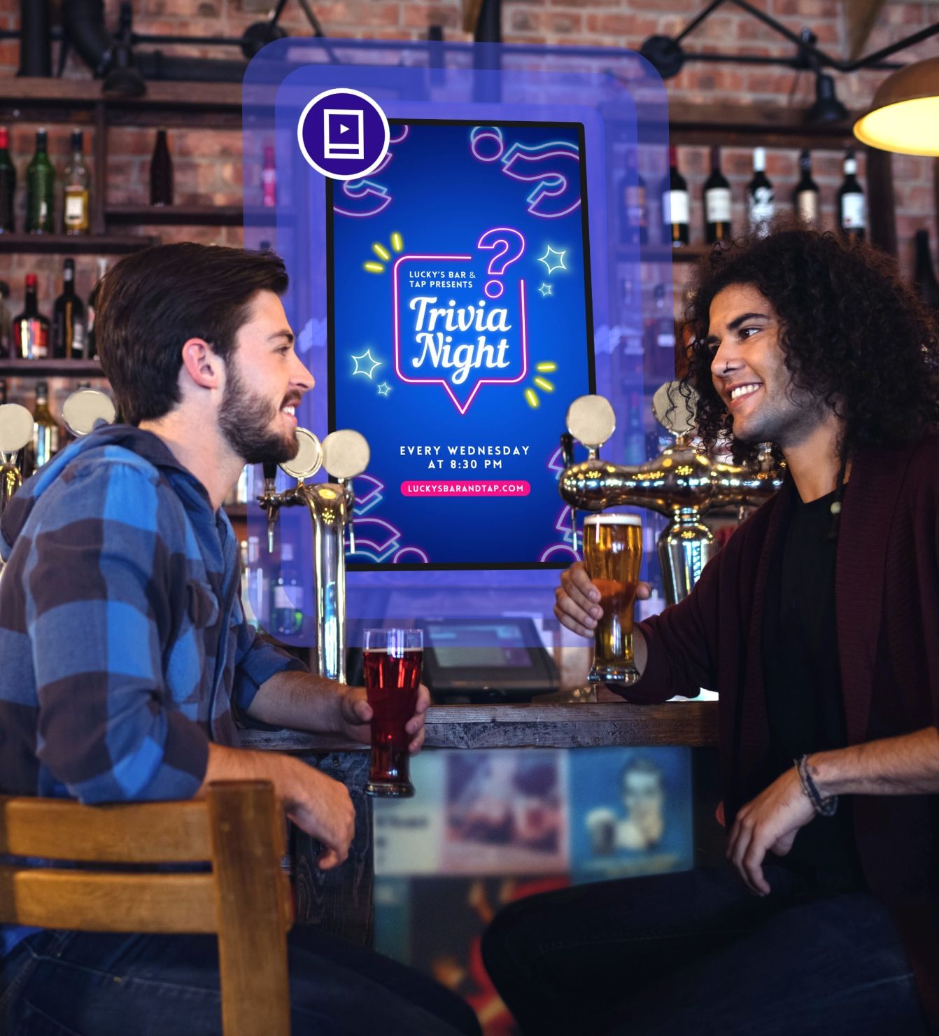 Friends at a bar with digital signage promoting trivia night