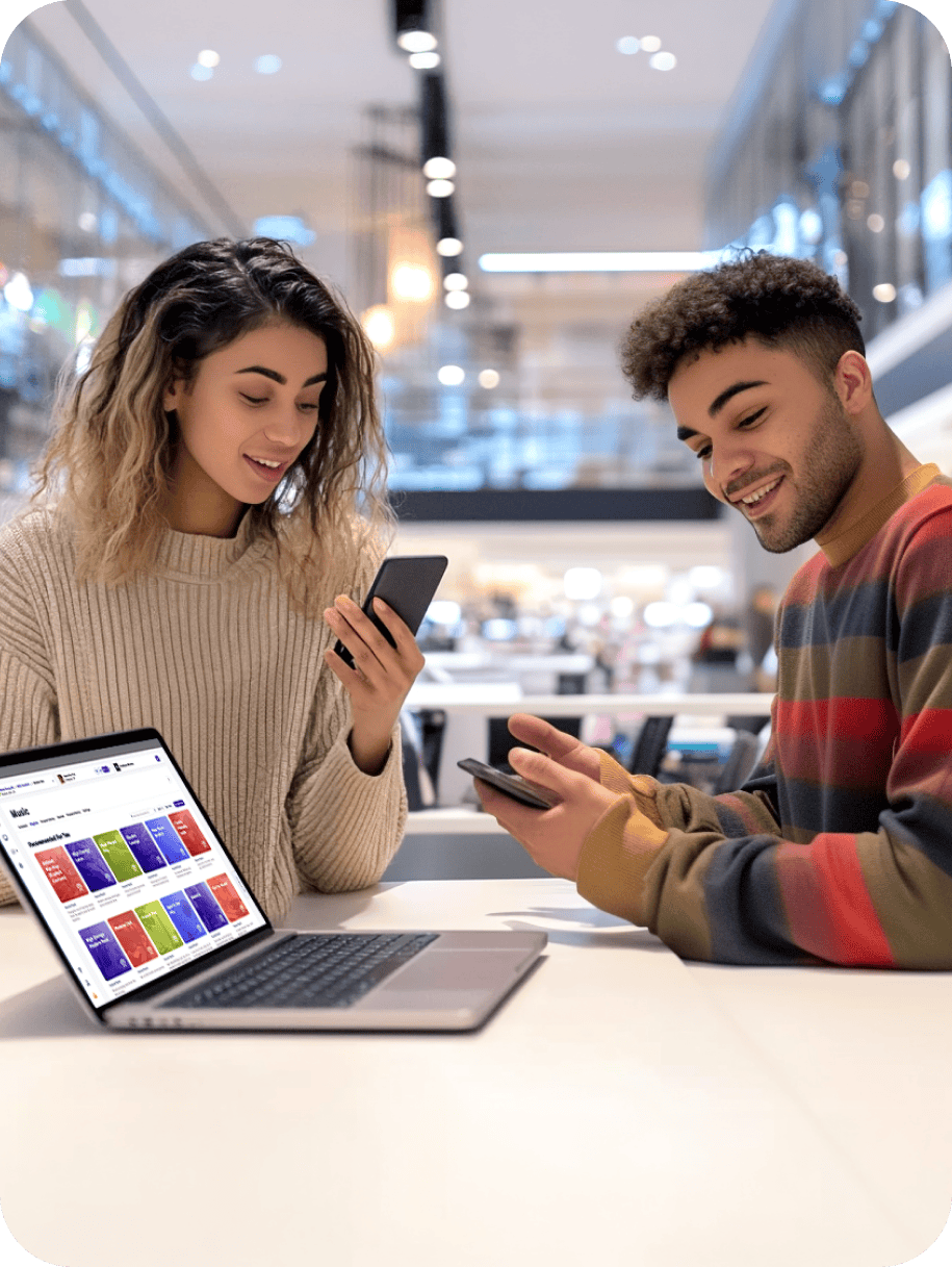 Image of a woman sitting at a desk talking into a mic and working on her computer