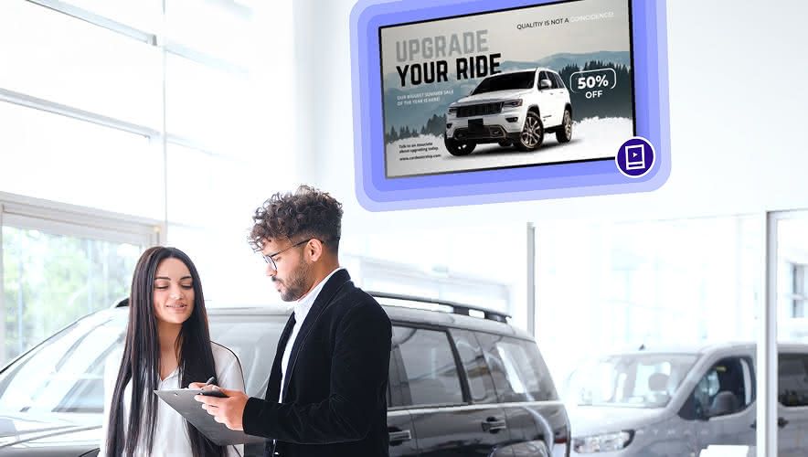 A woman speaking with a salesman while Rockbot Digital Signage is displayed behind them