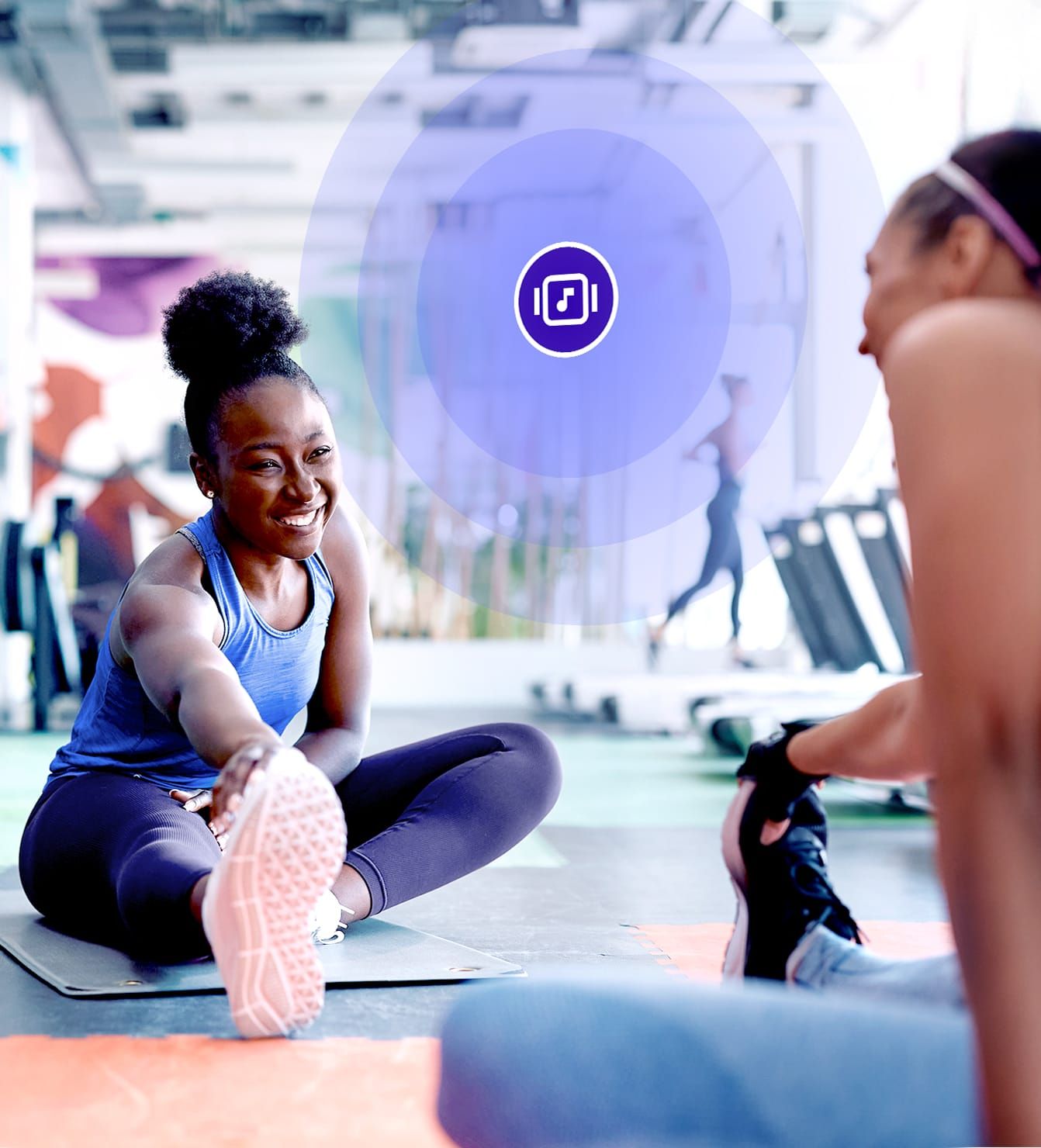 Women stretching on gym floor with Rockbot music enhancing workout atmosphere