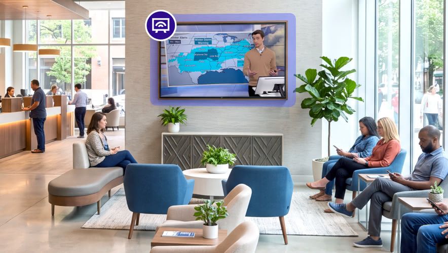 A group of people waiting in line at a bank while Rockbot Audio Messaging plays