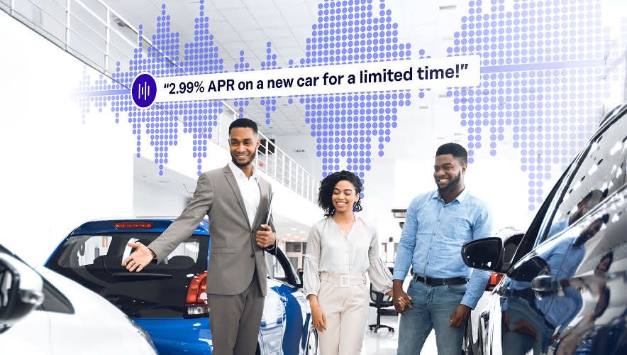 A couple speaking with a car salesman while Rockbot audio messaging plays in the background