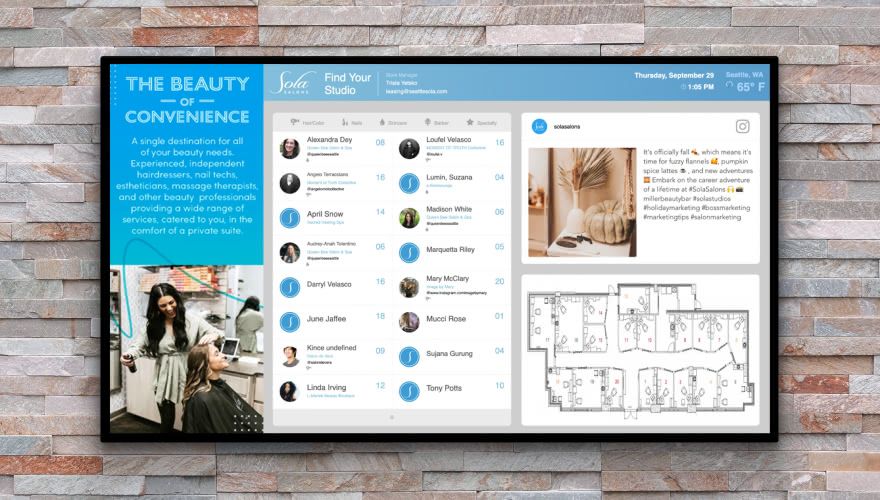 Sola Salon Studios digital directory displaying stylist listings and studio map on an in-salon screen