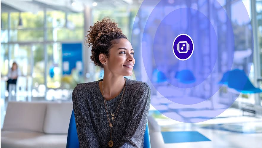 Woman waiting in a bank lounge listening to Rockbot Music