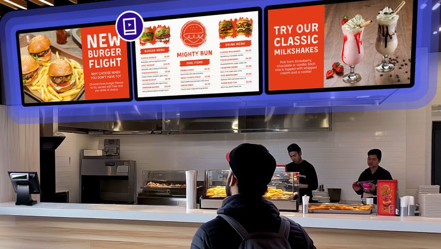 Someone standing at the counter of a quick service restaurant looking at the overhead Rockbot Menus