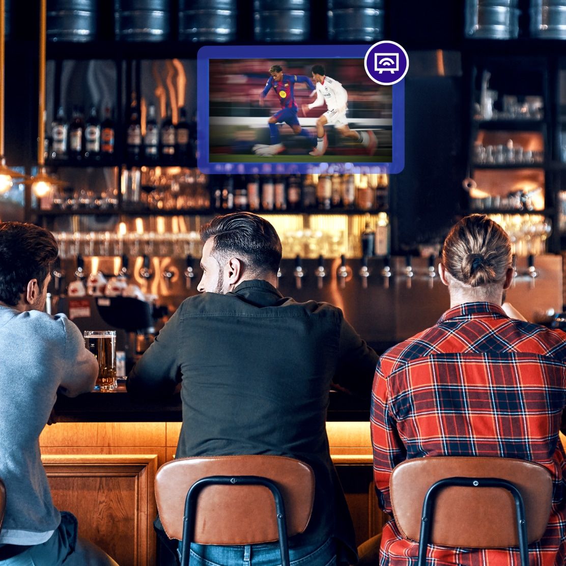 Bar setting with guests and Rockbot TV content on screen