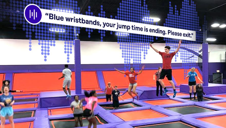 Altitude Trampoline Park guests jumping on trampolines with digital signage displaying audio messaging