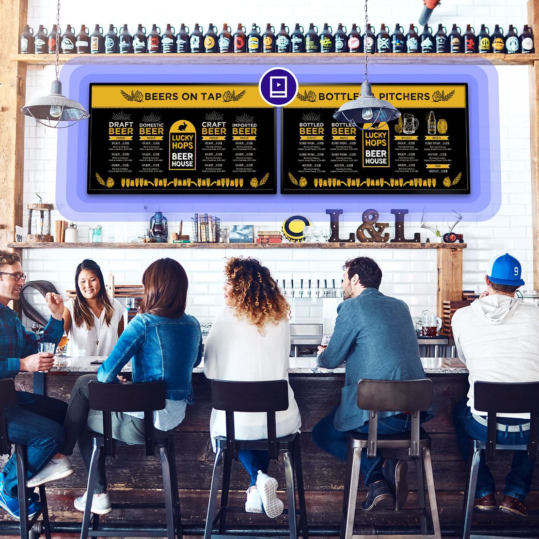 A group of people sitting behind the bar of a brewery with Rockbot Menus being shown in front of them