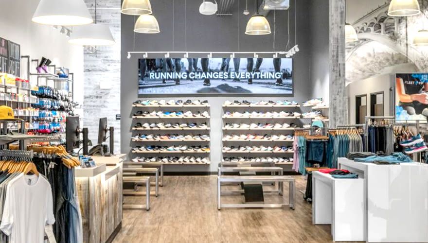 Fleet Feet retail store interior showing running apparel displays and digital signage