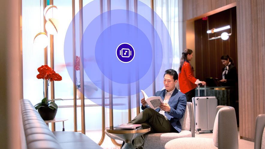 Hotel lobby with guests relaxing while licensed background music sets the mood