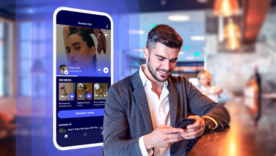 Man in a bar using the Rockbot Request App
