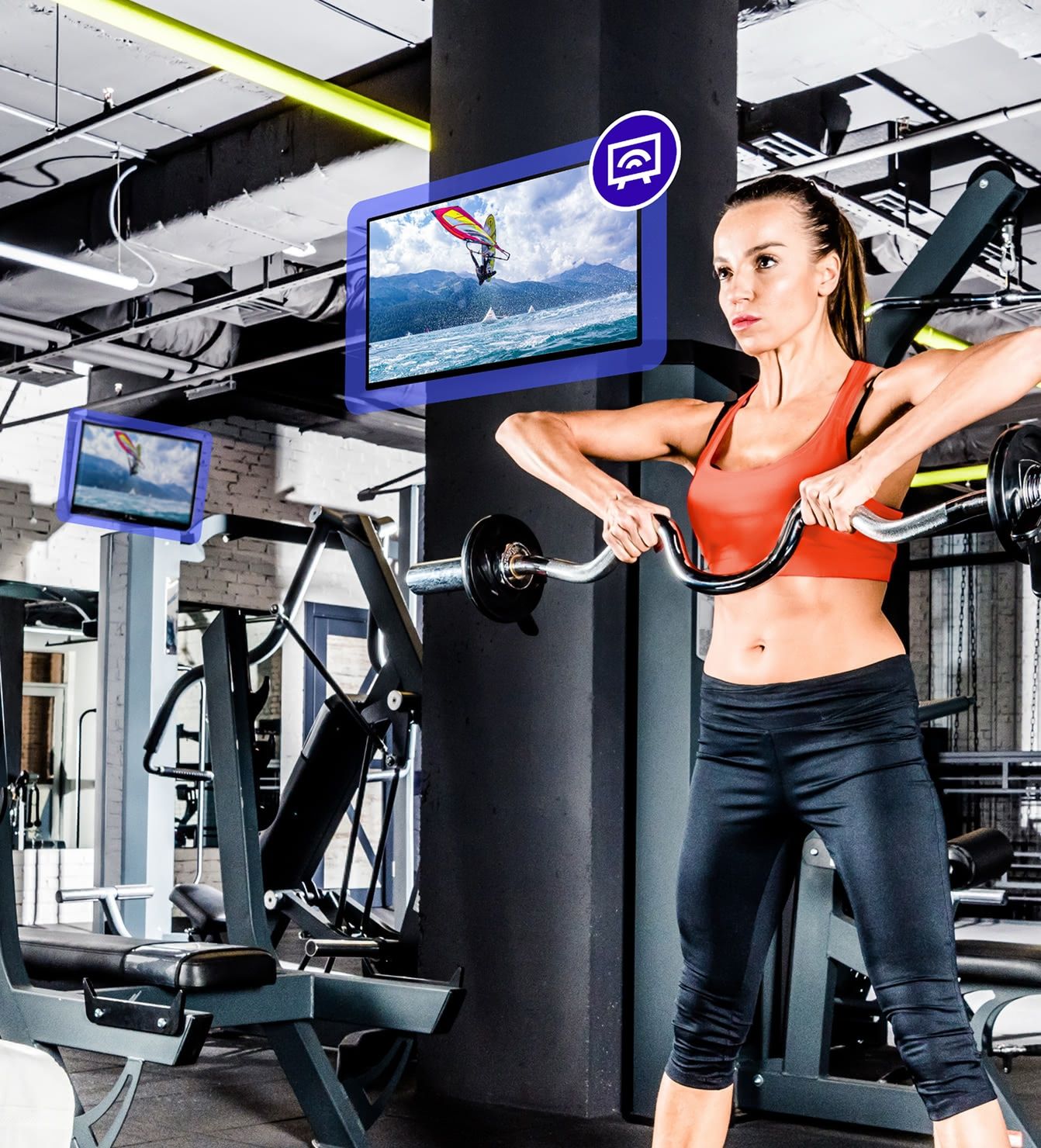 Woman working out on gym equipment with Rockbot TV mounted overhead