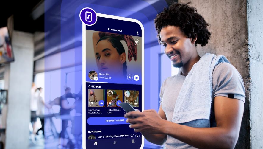 A man using the Rockbot Request app at a gym