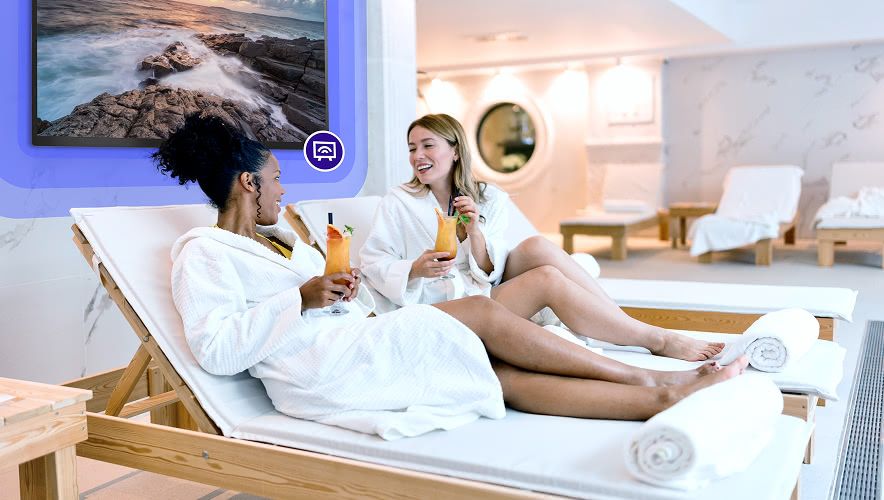Spa guests relaxing in a lounge area with curated TV content