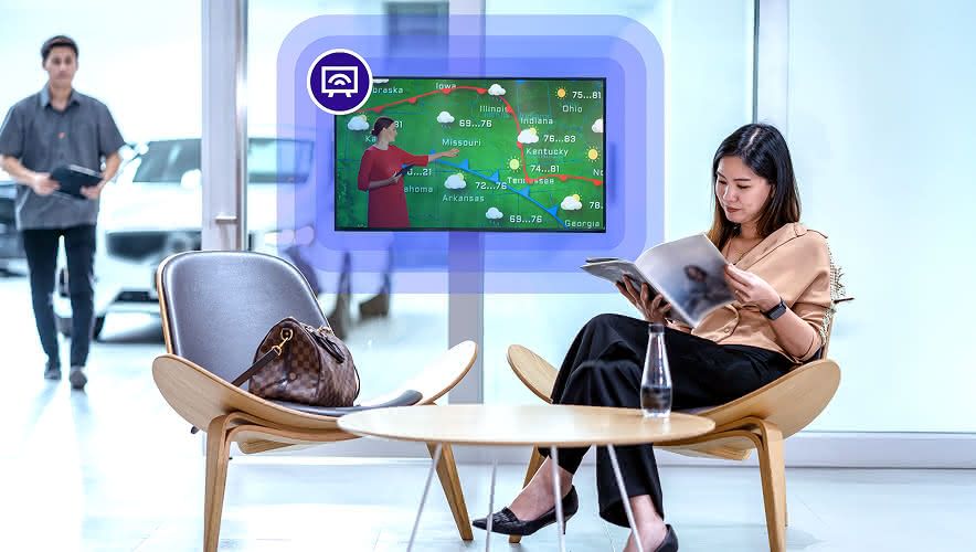 A woman waiting for her car while Rockbot TV plays