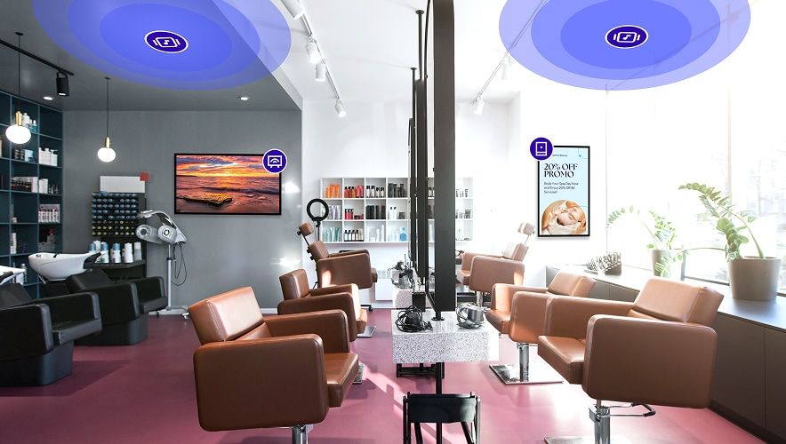 Modern salon interior with coordinated digital screens and media experiences