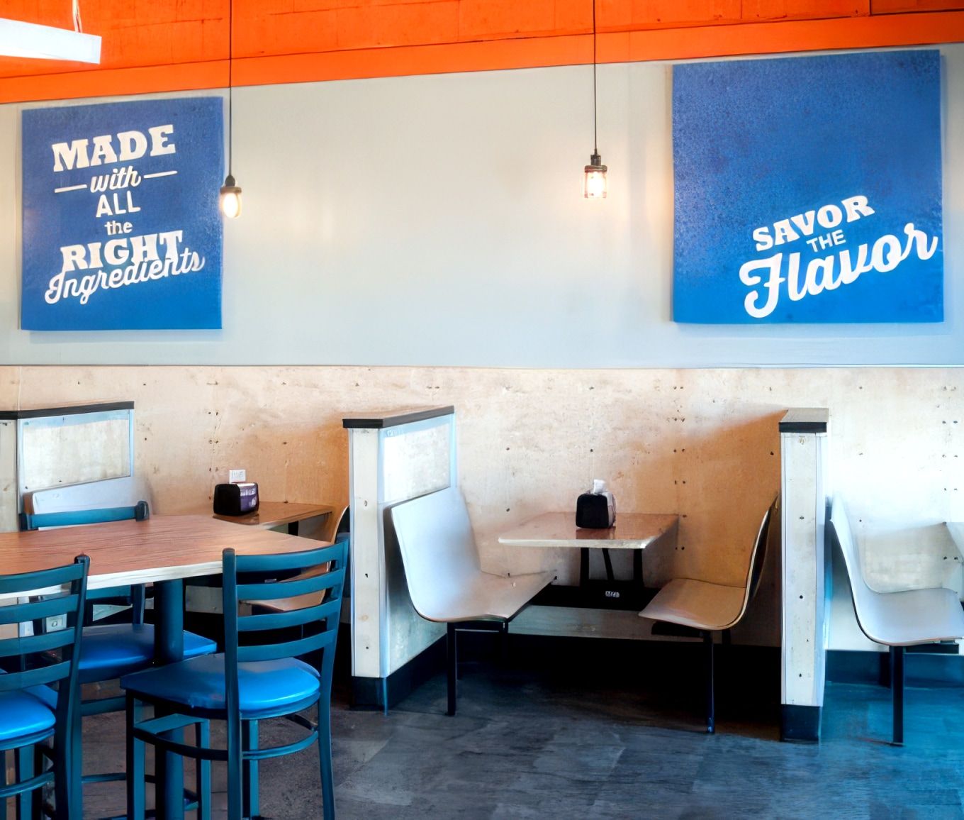 Hot Head Burritos dining room with branded wall signs at a franchise location