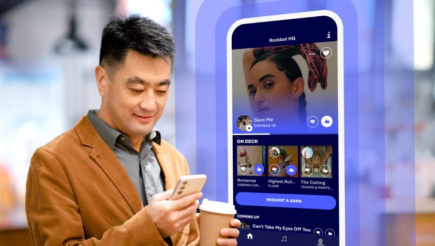 Customer using Rockbot Request App in a fast casual restaurant