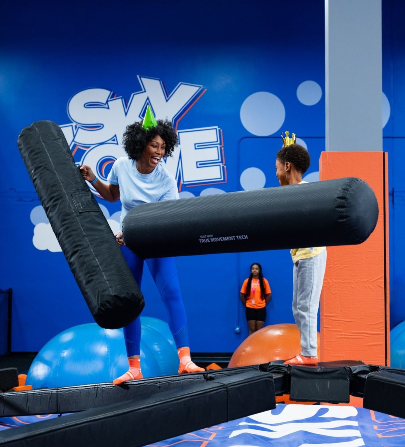 Guests enjoying a high-energy trampoline park experience with obstacle play and active fun