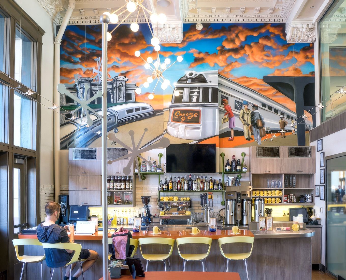 Snooze A.M. Eatery dining room with colorful mural and coffee bar