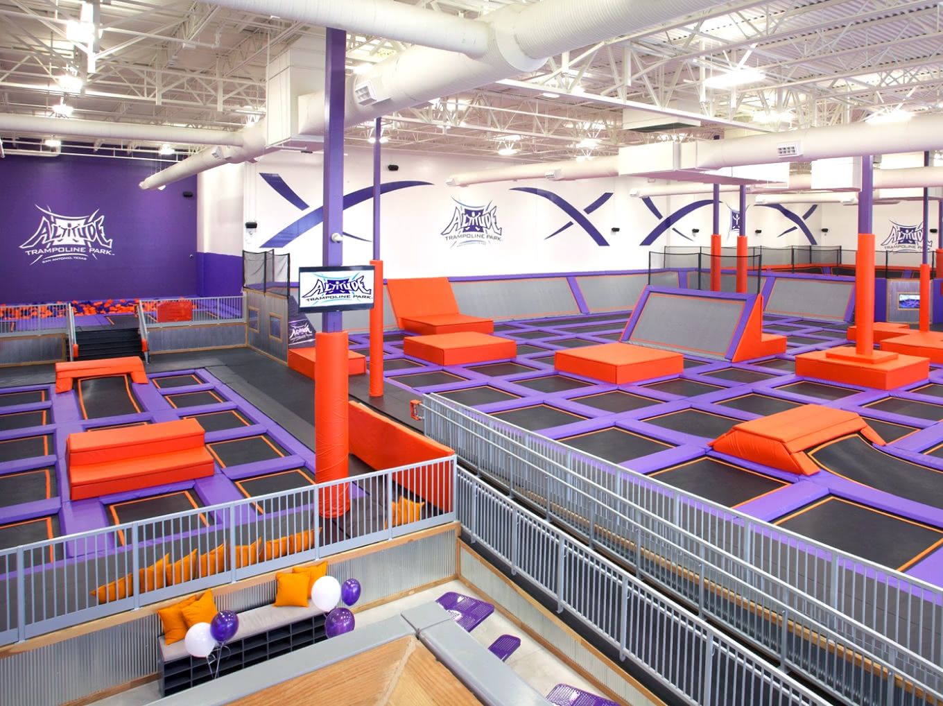 Busy Altitude Trampoline Park interior with multiple jump areas and guests in action