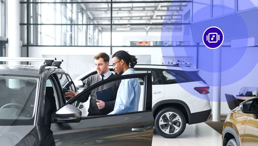 Two men looking at a car with Rockbot music playing in the background