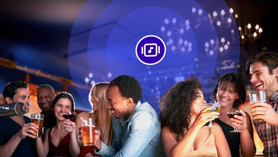 Friends enjoying drinks together with background music in a bar