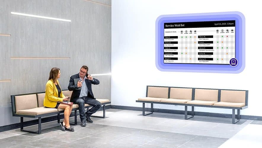 Two people waiting for their cars while a live waitlist is displayed in screen