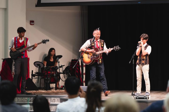 Photograph of musicians performing live on stage at the First Naga Baptist Fundraising Cultural Event.