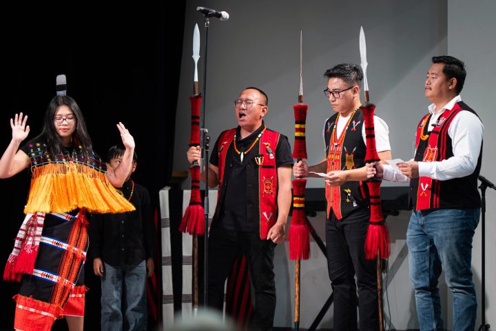 Photograph of performers celebrating together on stage at the First Naga Baptist Fundraising Cultural Event.