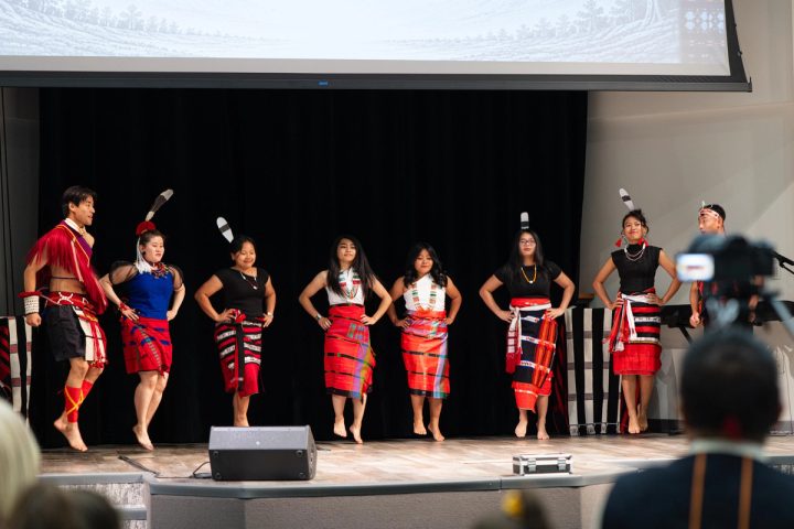 Photograph of dancers performing together on stage at the First Naga Baptist Fundraising Cultural Event.
