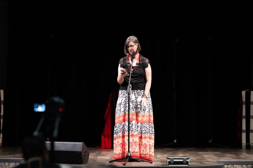 Photograph of a singer performing on stage at the First Naga Baptist Fundraising Cultural Event.