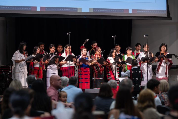 Photograph of a large group of performers gathered on stage at the First Naga Baptist Fundraising Cultural Event.