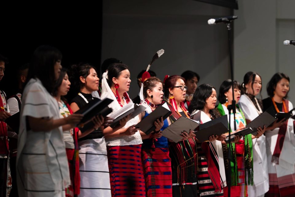 Photograph of a choir singing together on stage at the First Naga Baptist Fundraising Cultural Event.